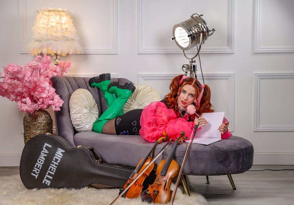 Photo of Michelle Lambert with two violins.